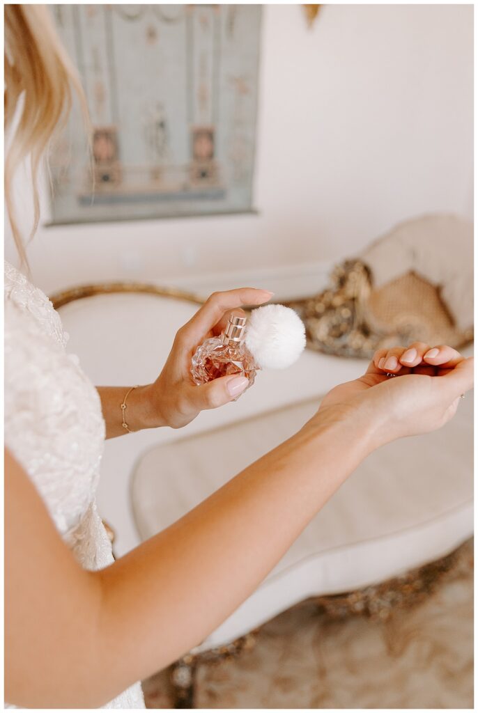 bride with vintage perfume for wedding day packing list.