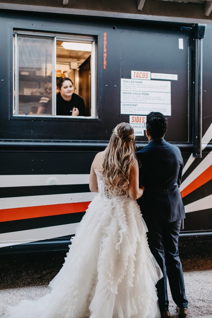 Bride and groom at food truck. 