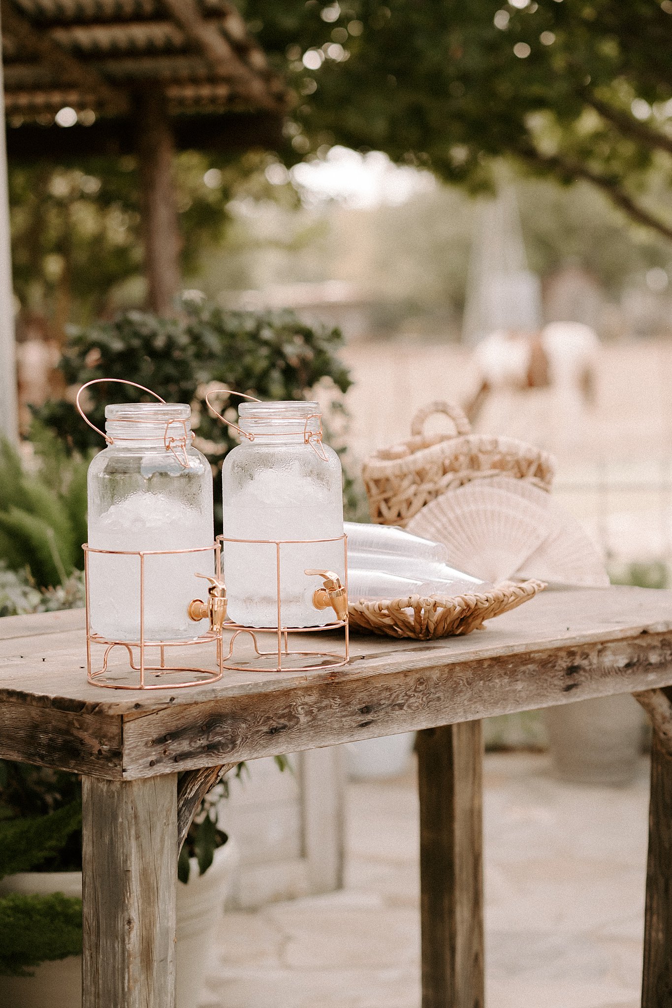 A couple's mistakes when planning their wedding become evident as they set two jars of water on a wooden table.