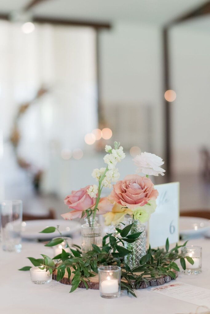 A Pecan Springs Ranch table adorned with flowers and candles.