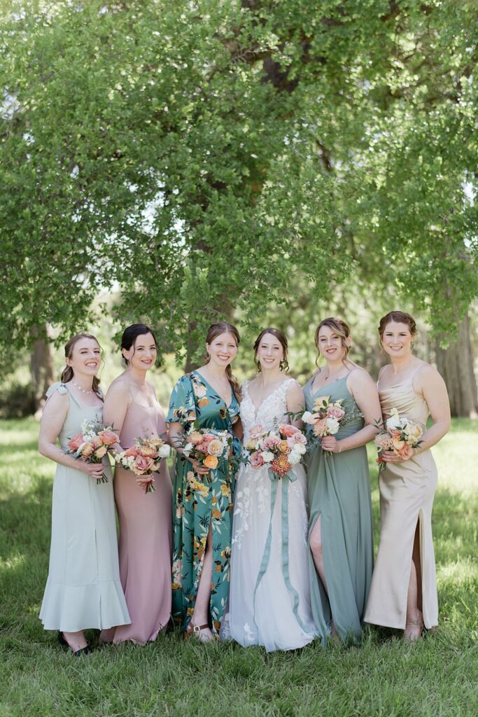 A group of bridesmaids wearing mix-matched dresses that can be re-worn in the future. 