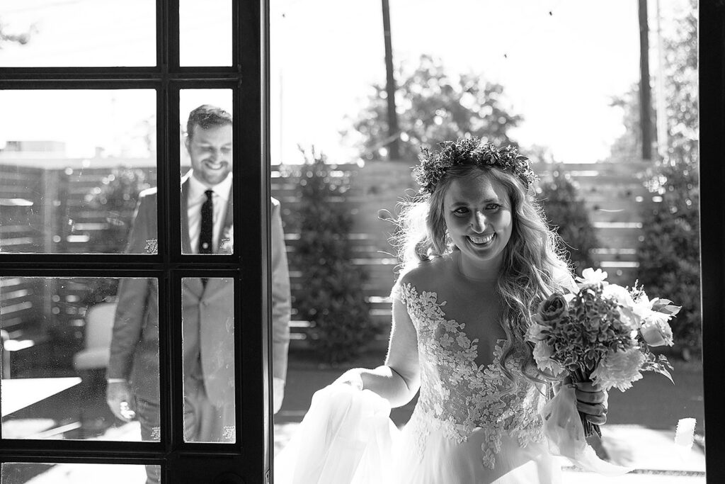 A bride and groom walking through a doorway.