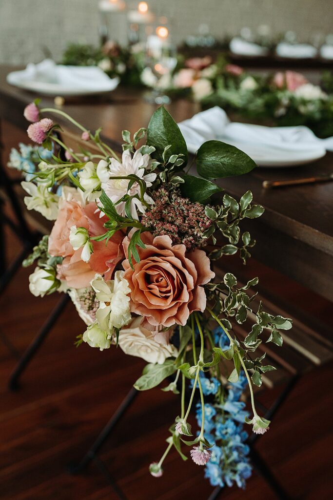 An arrangement of flowers on a wooden table.