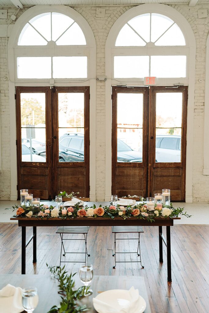 A table set up in a room with large windows.