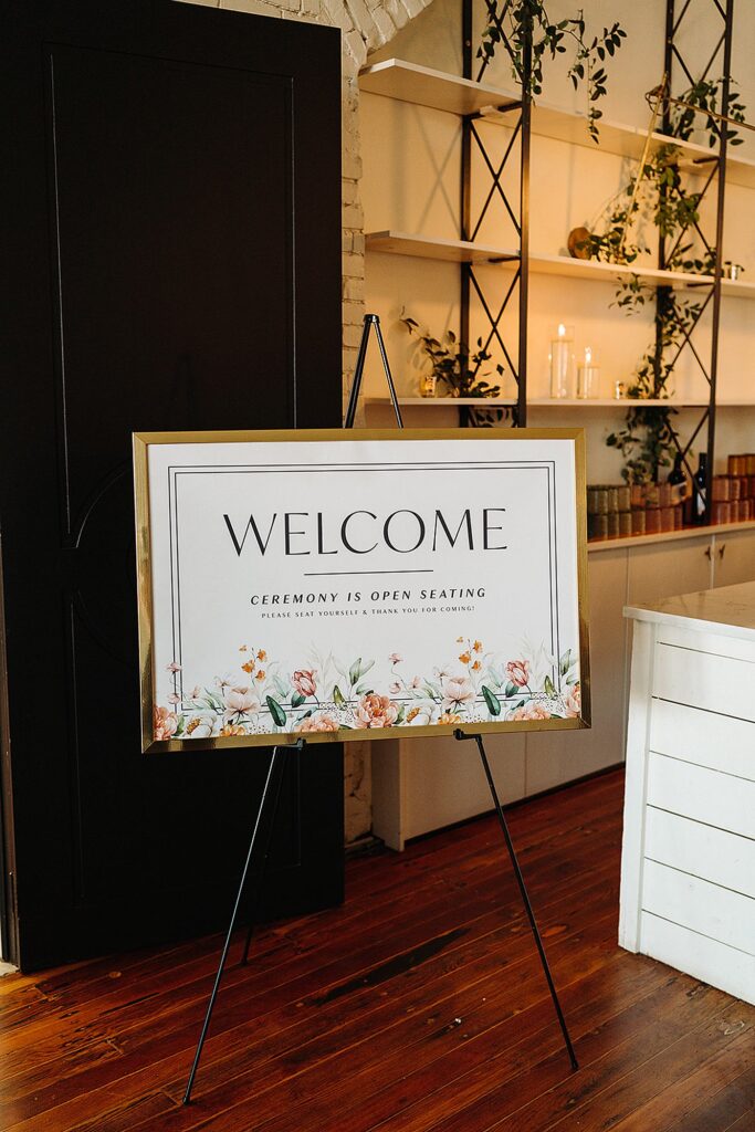 A welcome sign on an easel in a room.