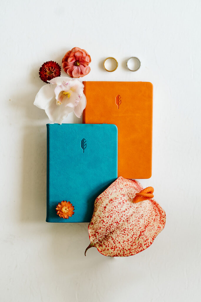 A blue and orange notebook with a flower and ring, perfect for capturing memories