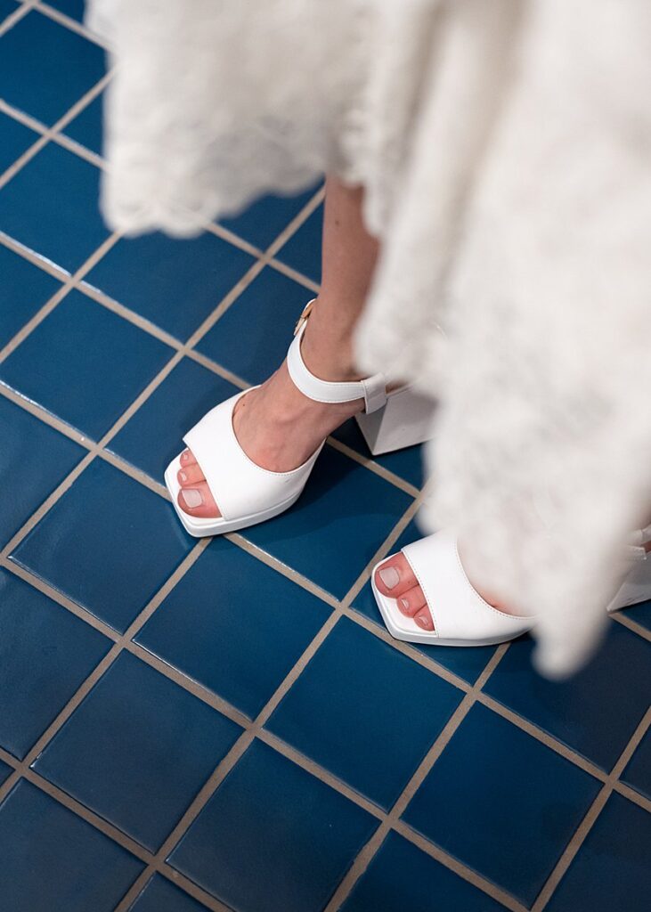 bride's shoes on a tile floor.