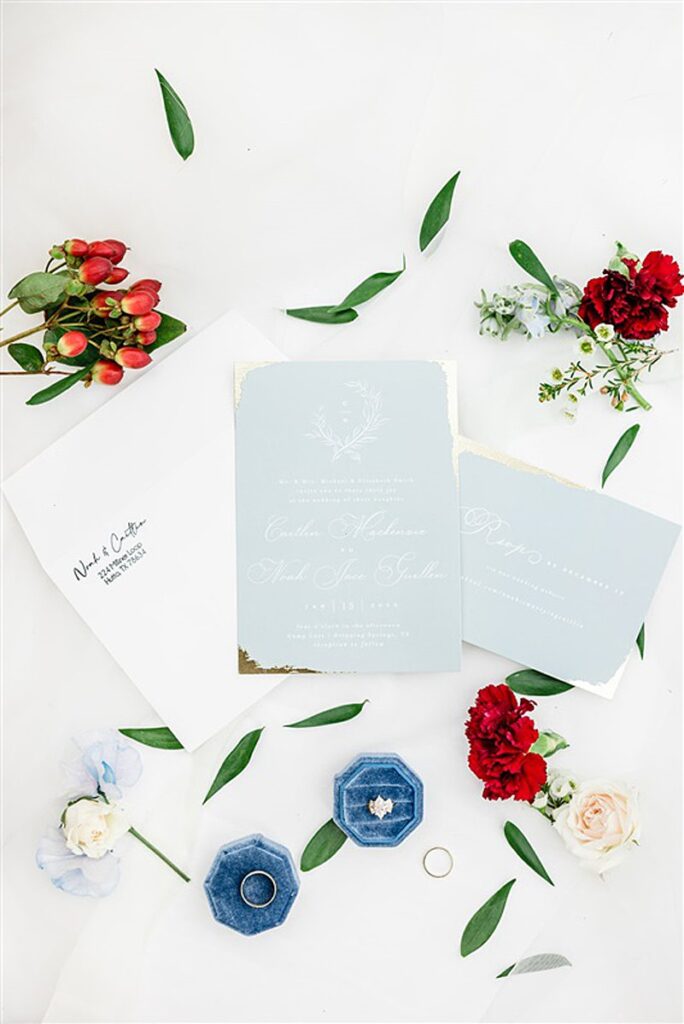 A Camp Lucy wedding invitation adorned with exquisite flowers.
