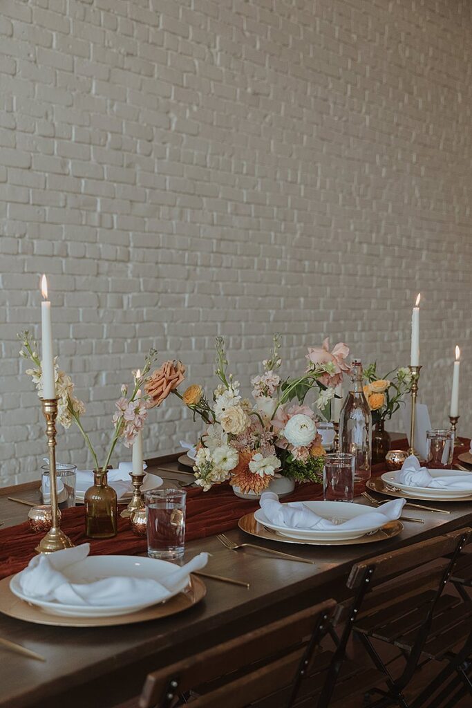 A table set up with candles and flowers for at One Eleven east wedding. 