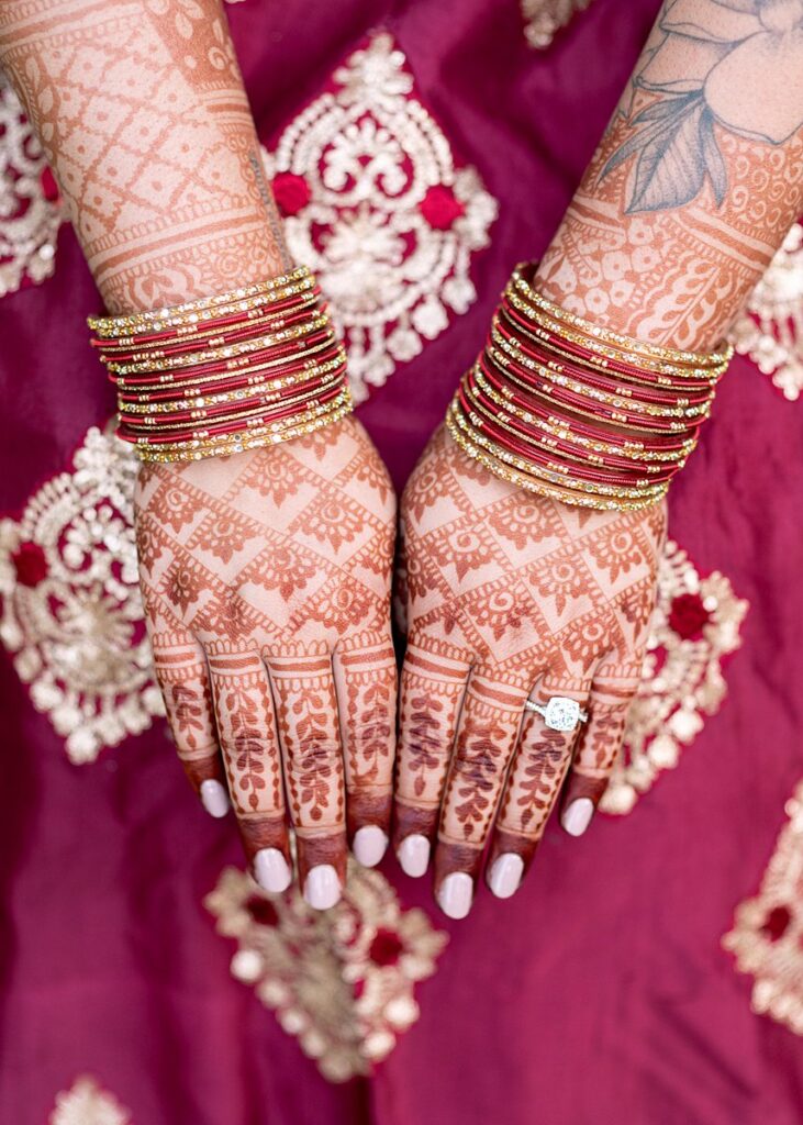 A bride with henna tattoos on her hands.