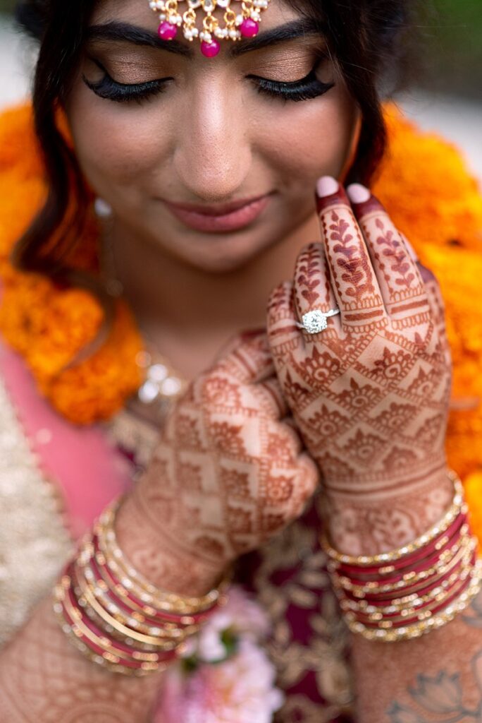An Indian bride with henna on her hands at a wedding.