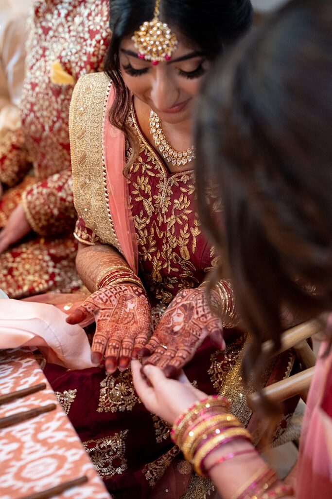 Indian brides at Hotel Magdalena Wedding putting on henna on their hands.