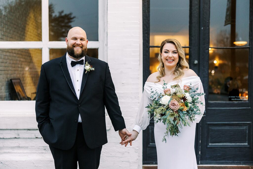 Couple standing outside of the One Eleven East Wedding Venue.