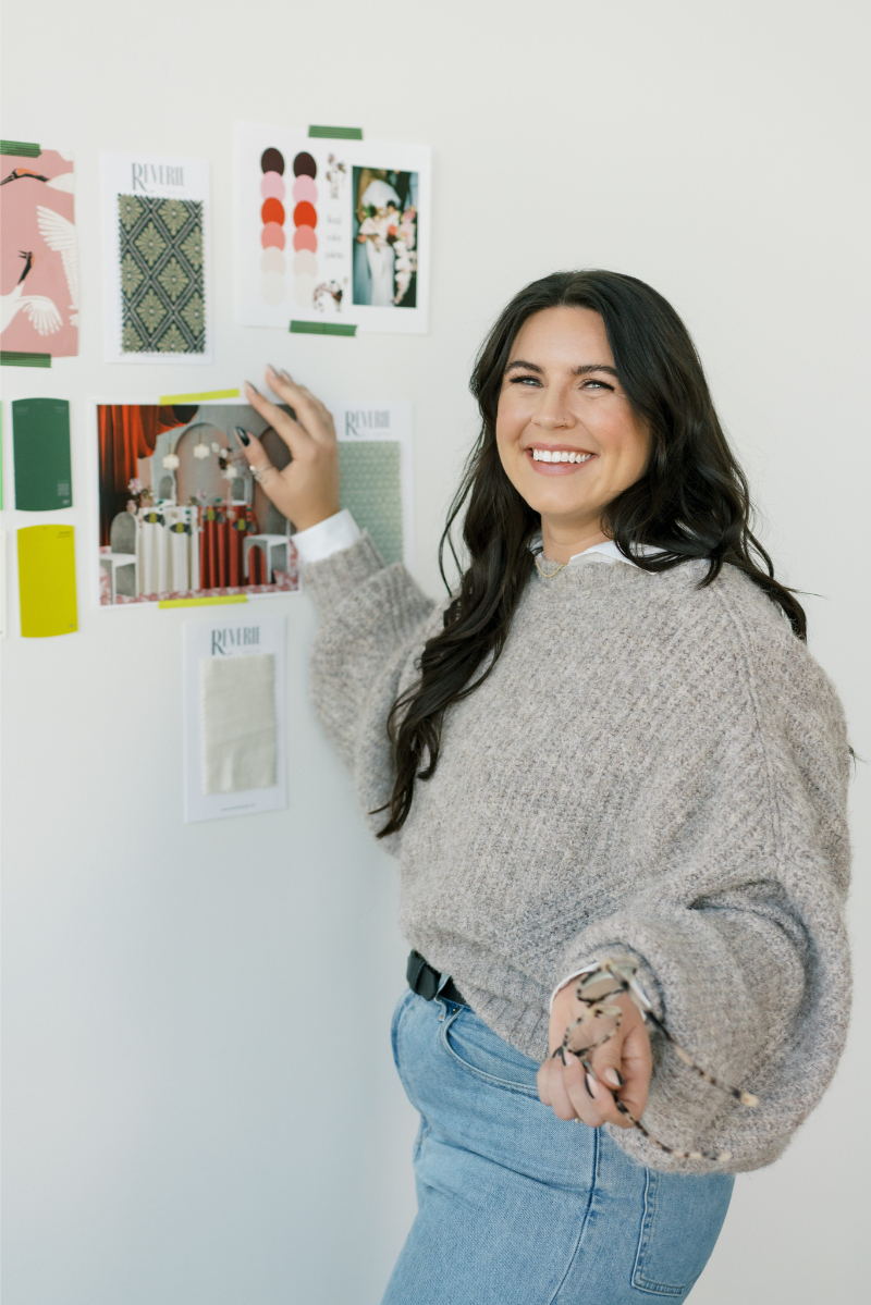 Sydney Meyer, lead Austin wedding planner of In Ink Weddings, poses for photo with mood board behind her as she talks about reasons to hire a wedding planner.
