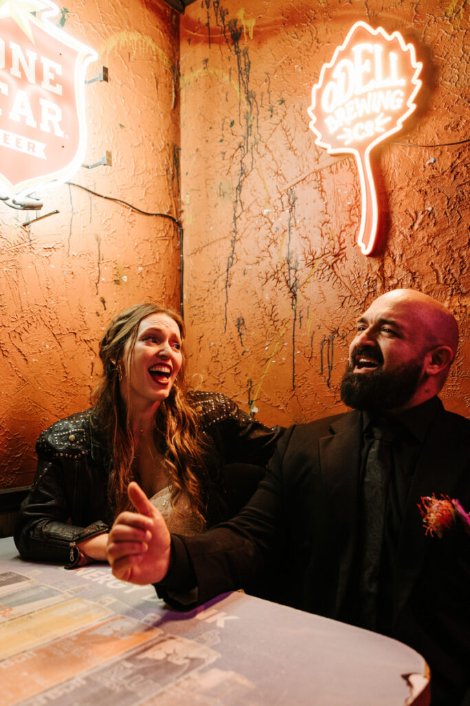 Bride and groom sing karaoke together during wedding afterparty. 