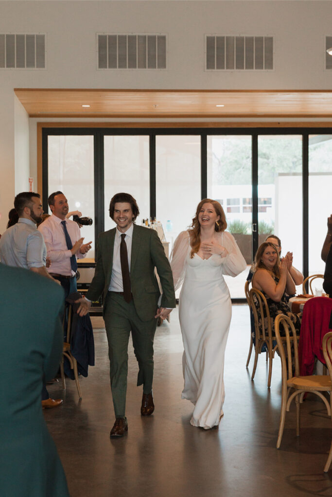 Bride and groom enter reception hall at The Grand Lady Austin.