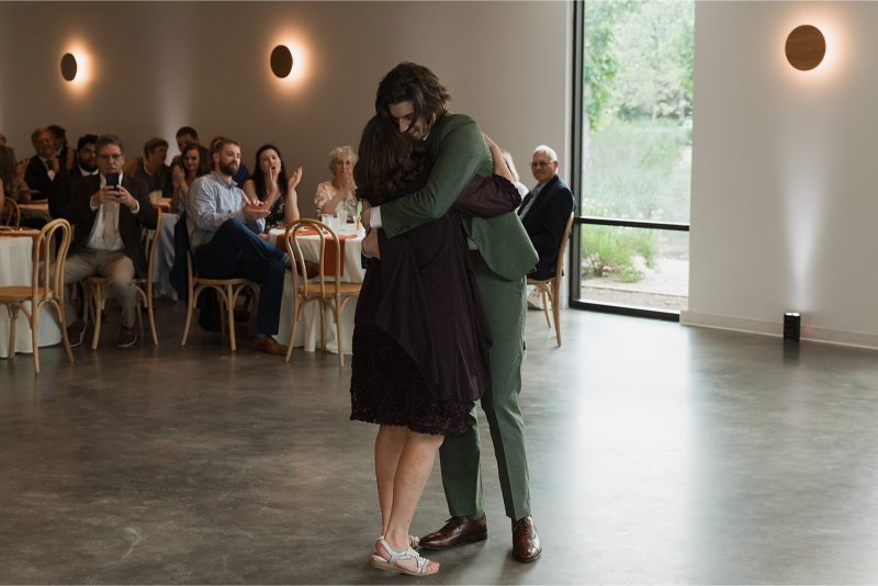 Groom shares dance with mother in the reception hall at The Grand Lady Austin.