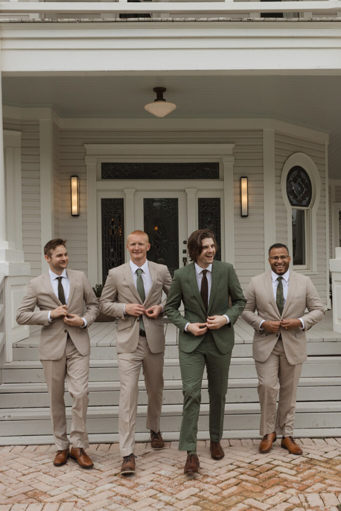 A bridal party take portraits outside of the mansion of The Grand Lady Austin. 