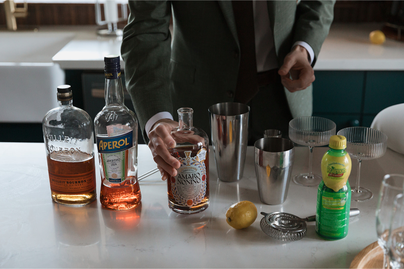 Bride and groom make cocktails in the kitchen of The Grand Lady Austin. 