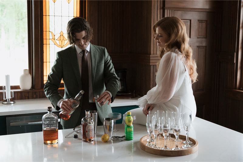 Bride and groom make cocktails in the kitchen of The Grand Lady Austin. 