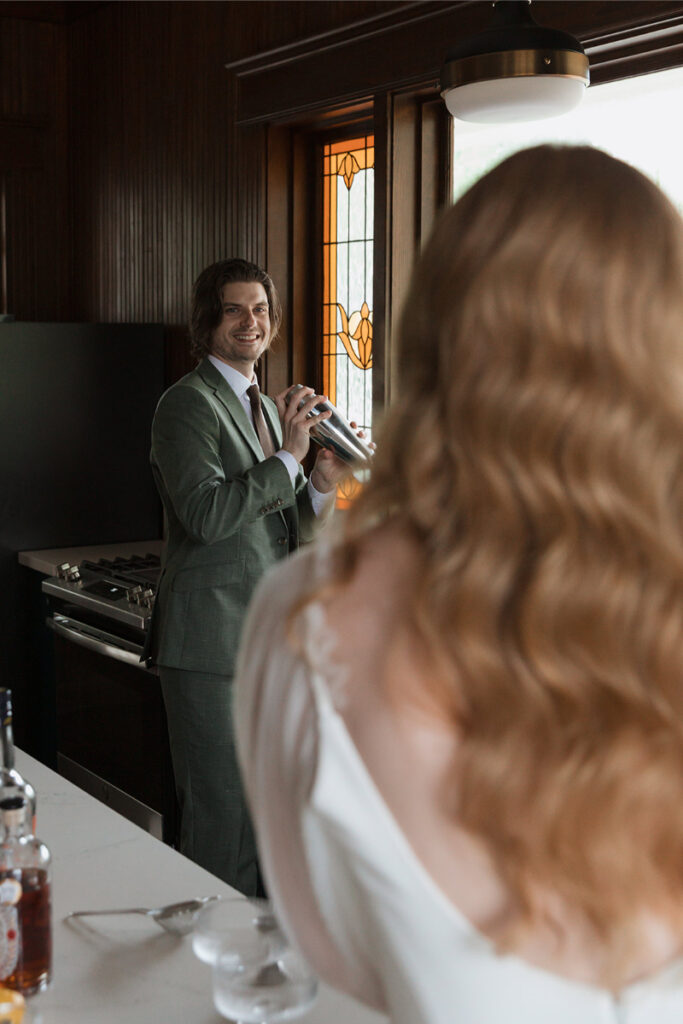 Bride and groom make cocktails in the kitchen of The Grand Lady Austin. 