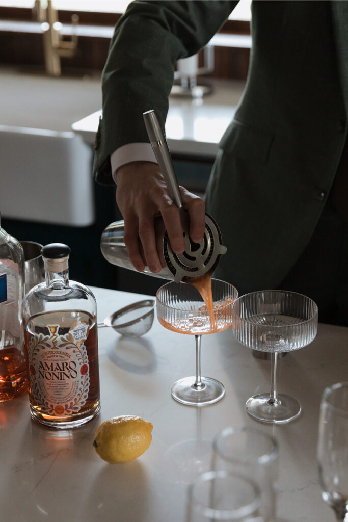 Bride and groom make cocktails in the kitchen of The Grand Lady Austin. 