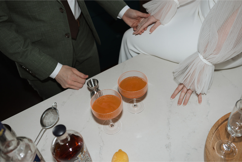 Bride and groom make cocktails in the kitchen of The Grand Lady Austin. 