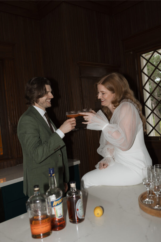 Bride and groom make cocktails in the kitchen of The Grand Lady Austin. 