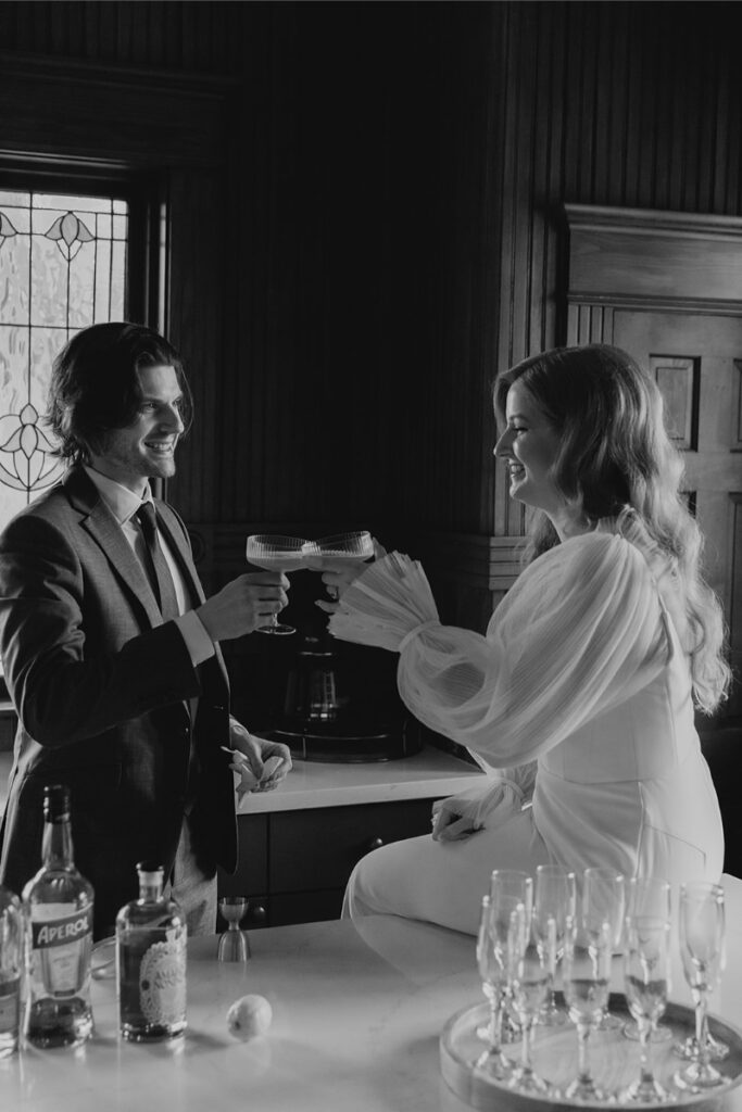 Bride and groom make cocktails in the kitchen of The Grand Lady Austin. 