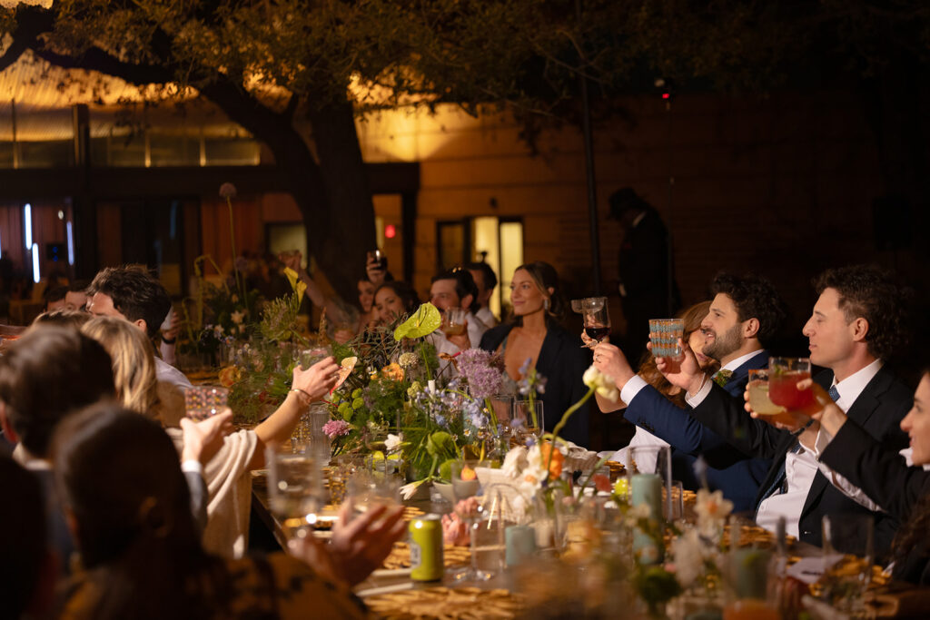 Bride and groom sharing toast with guests at Austin luxury wedding.
